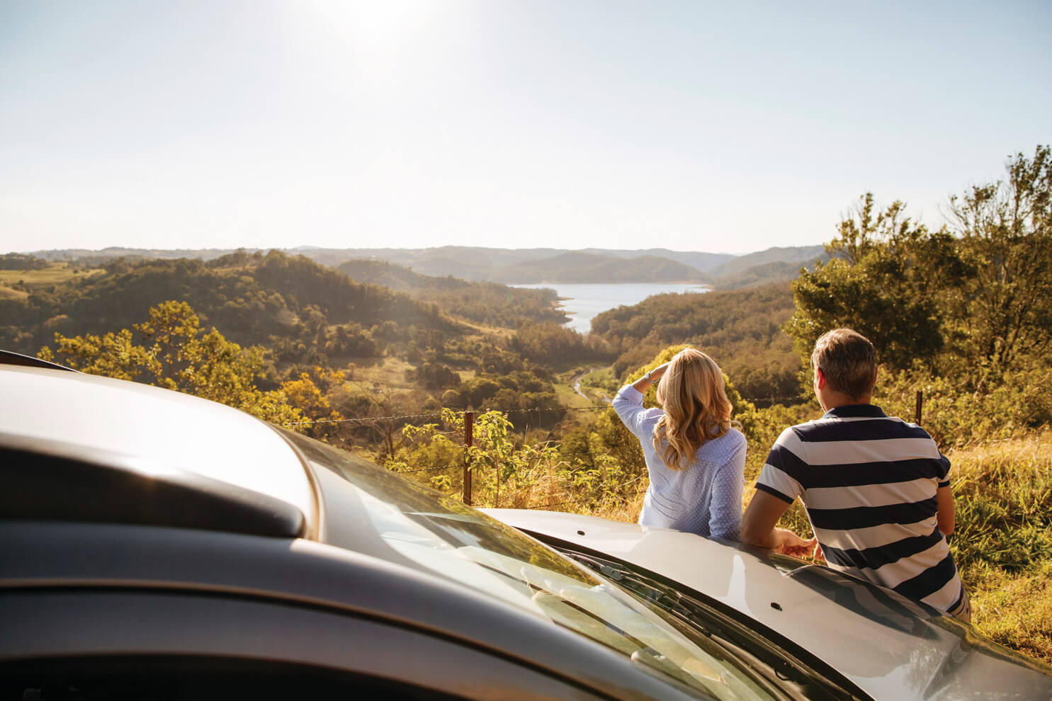 Sunvan Caravans about us image of two people on camping trip looking at gorgeous view